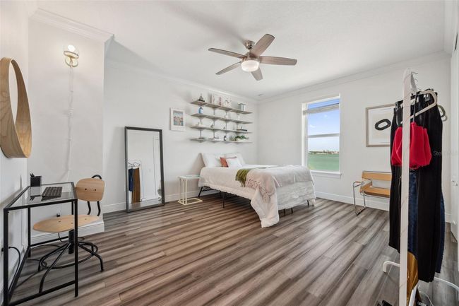 This secondary master bedroom is located on the 3rd floor and features a water view. | Image 60