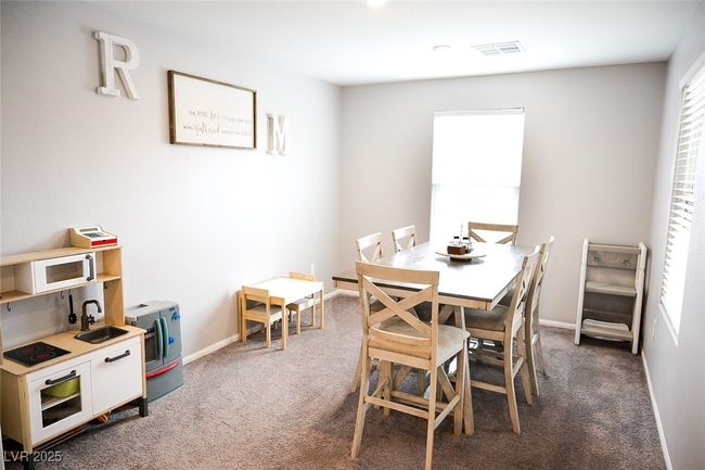 Carpeted dining area with baseboards and a sink | Image 14