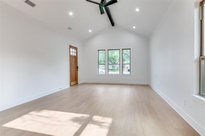 Empty room with high vaulted ceiling, beam ceiling, and light wood-type flooring | Image 2