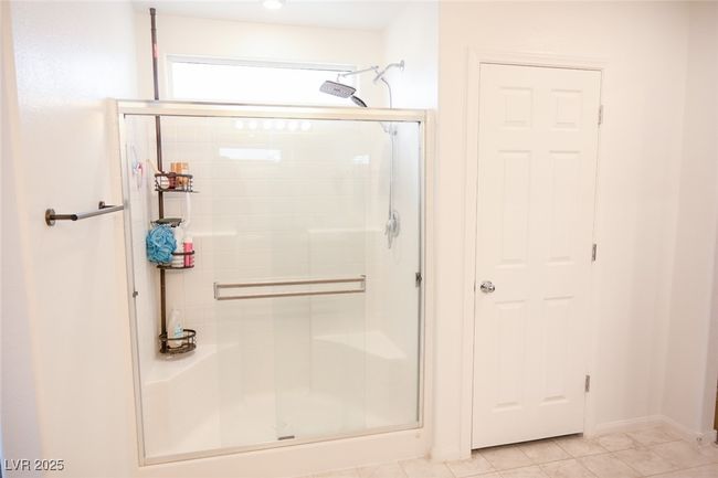 Full bathroom featuring baseboards, tile patterned flooring, and a stall shower | Image 27