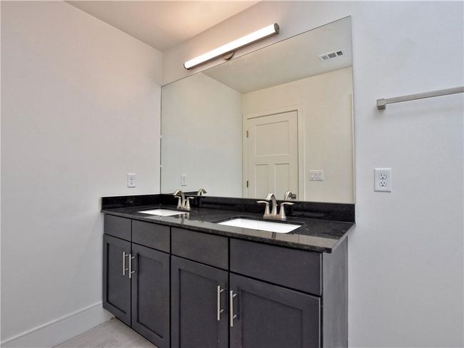 Full bathroom with double vanity and baseboards | Image 20