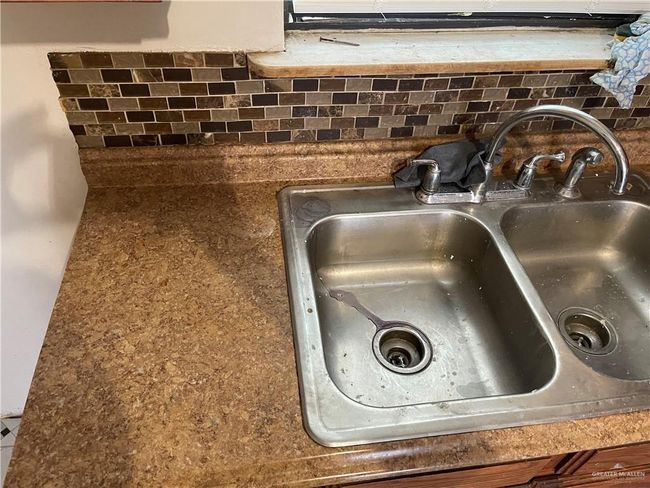 Kitchen view of a sink and backsplash | Image 9