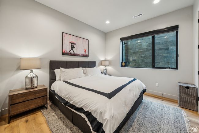 Bedroom featuring baseboards, light wood-style flooring, visible vents, and recessed lighting | Image 46