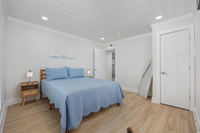 Bedroom with recessed lighting, baseboards, crown molding, and light wood-style flooring | Image 27