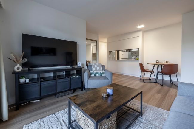 Living area featuring baseboards and wood finished floors | Image 5