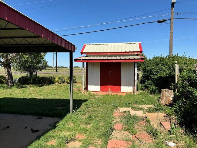 View of yard featuring a carport and a storage shed | Image 6