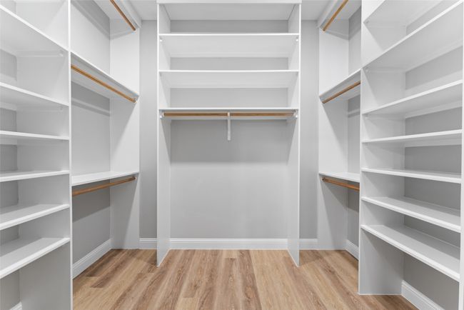 Walk in closet featuring wood finished floors | Image 24