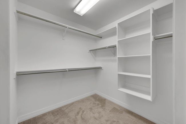 Spacious closet with carpet floors | Image 22