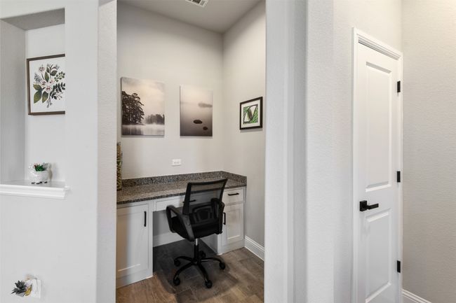Office with dark wood-type flooring and built in study area | Image 20