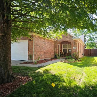 View of front of house featuring a garage and a front yard | Image 1