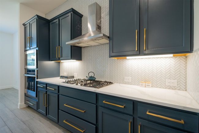 A look at the under cabinet lighting and elegant cabinetry throughout the kitchen. | Image 13