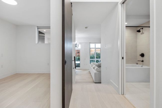 Corridor with baseboards and light wood-style floors | Image 12
