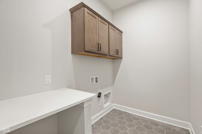 Laundry room is conveniently located on the main level. | Image 25