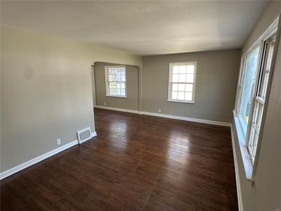 Spare room with a wealth of natural light and dark hardwood / wood-style floors | Image 2