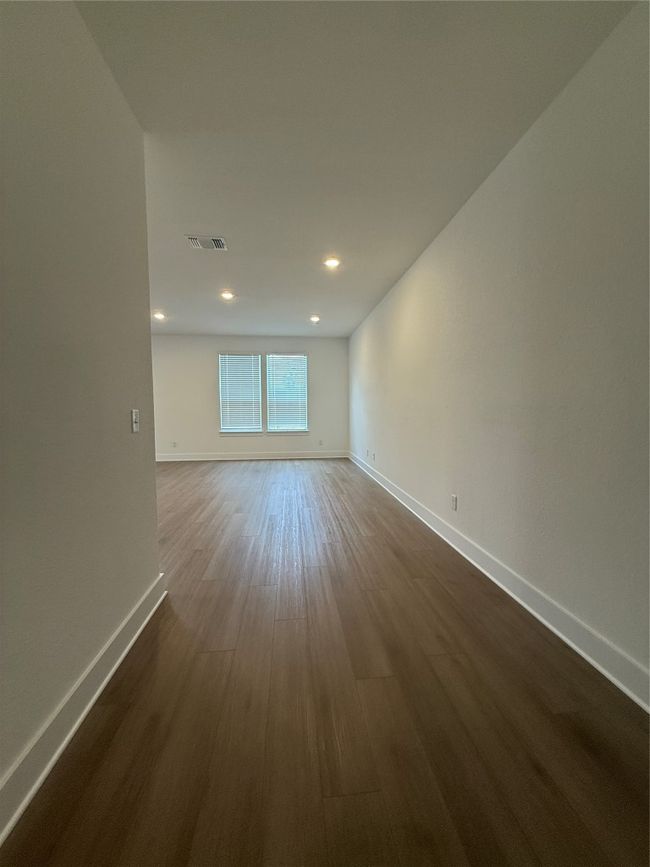 Empty room featuring baseboards, dark wood-style flooring, and recessed lighting | Image 11