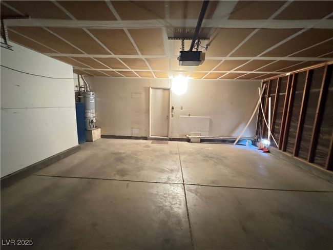 Garage with a garage door opener and secured water heater | Image 31