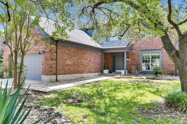 View of front of house with a garage, brick siding, roof with shingles, and a front lawn | Image 36