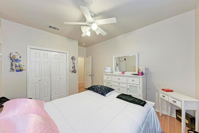 Bedroom featuring light wood-style floors, a closet, and ceiling fan | Image 28