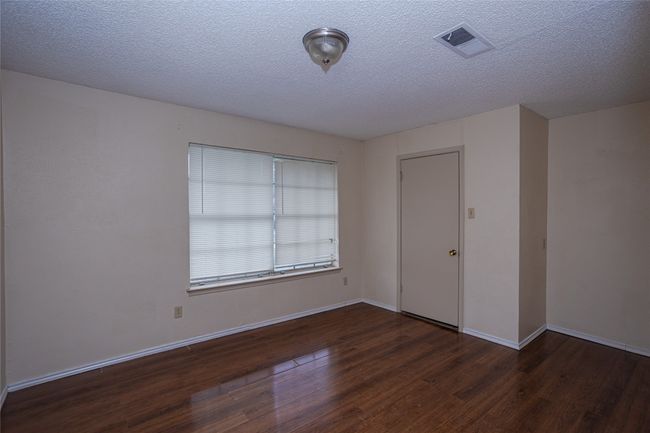 Bedroom 3 featuring wood finished floors and a textured ceiling | Image 17