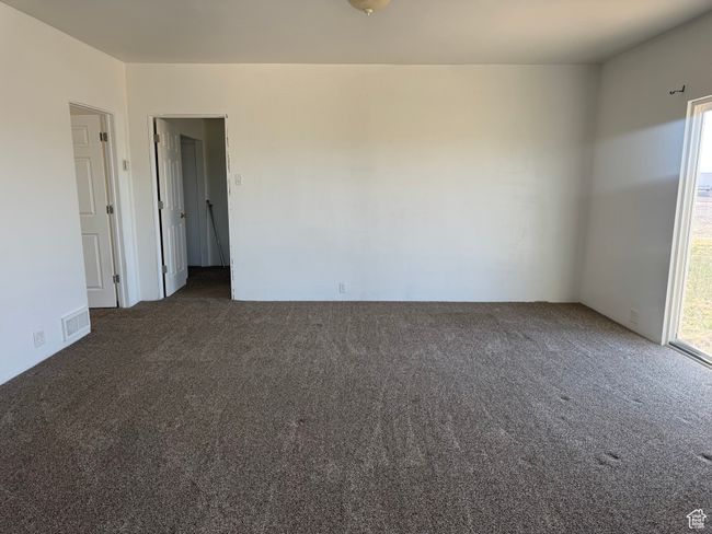 Empty room with visible vents and carpet | Image 34