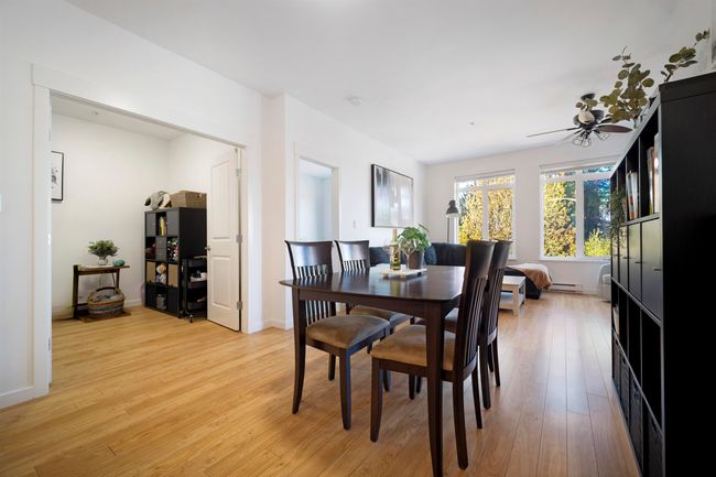 Dining area with light wood-type flooring, baseboard heating, baseboards, and ceiling fan | Image 20