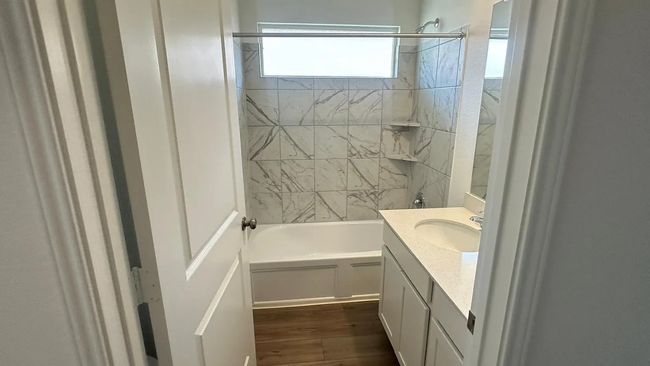 Bathroom featuring vanity, shower / bath combination, and dark wood-style flooring | Image 14