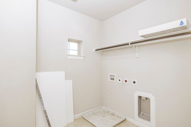 Laundry room featuring electric dryer hookup, washer hookup, and light tile patterned floors | Image 25