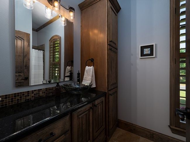 Full bathroom with baseboards, vanity, backsplash, and a healthy amount of sunlight | Image 26