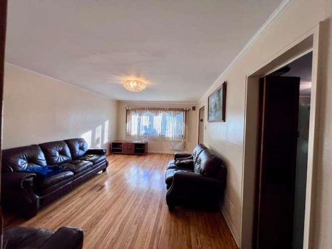 Living room with crown molding and wood finished floors | Image 5