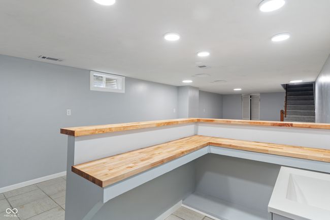 bar with baseboards, stairway, and recessed lighting | Image 37