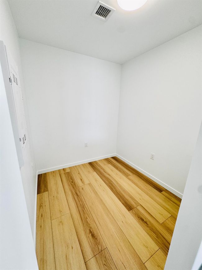 Empty room featuring baseboards, visible vents, and wood finished floors | Image 15