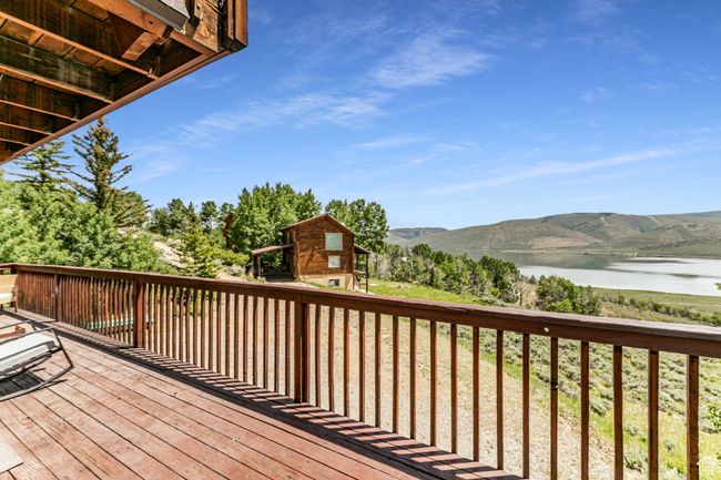 Wooden deck featuring a water and mountain view | Image 26