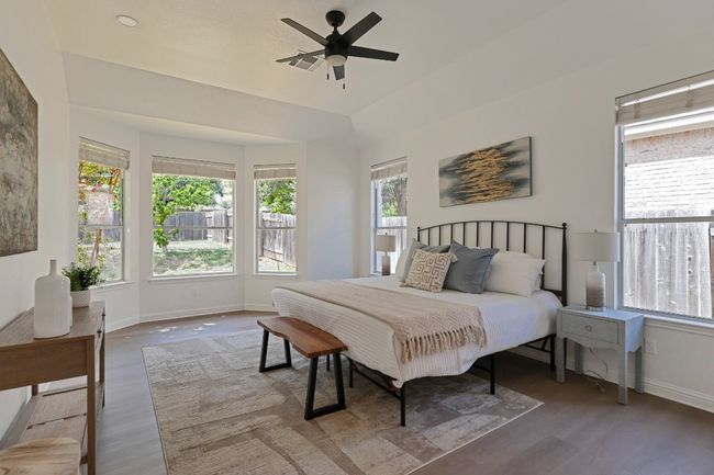 Bedroom with wood finished floors and ceiling fan | Image 14