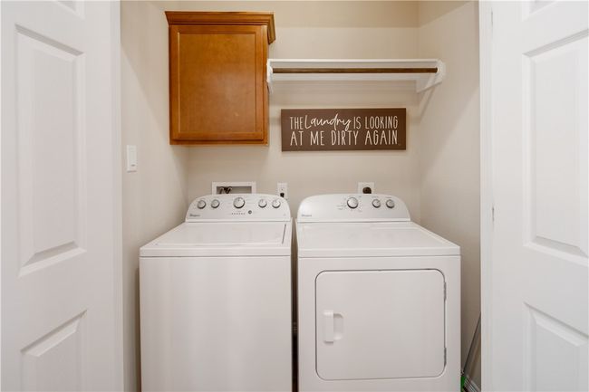 Laundry area featuring washer and dryer and cabinet space | Image 14