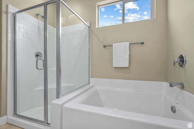 Bathroom featuring a shower stall and a bath | Image 17