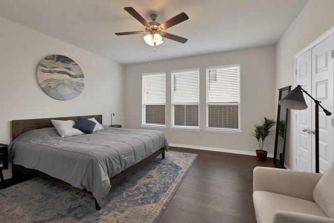 Bedroom featuring baseboards, dark wood-style floors, and a ceiling fan | Image 19