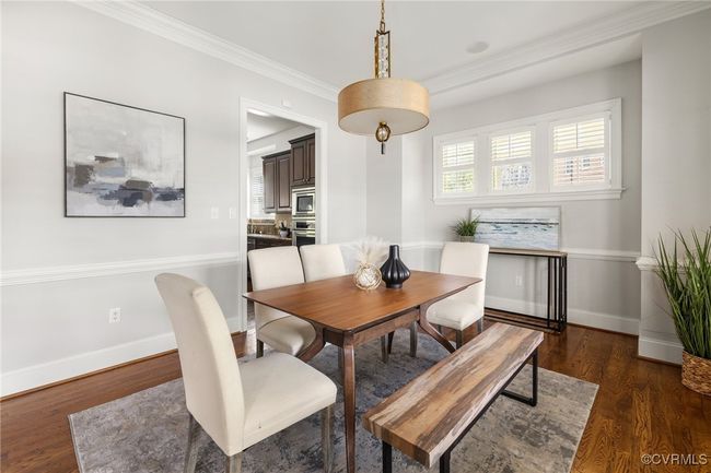 10' ceilings, 8' open casement; chair rail, designer light fixture, plantation shutters, site finished hardwood floors | Image 7