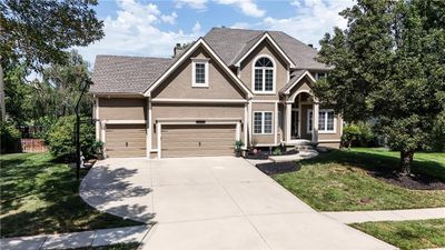 View of front of house featuring a front lawn and a garage | Image 1