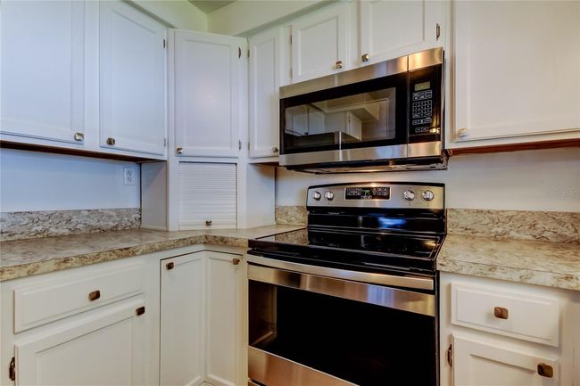 20. FULLY UPDATED Kitchen (9.2' x 8.9') w Convenient Corner Appliance Garage! NICE Stainless Appliances, White Cabinets, Gorgeous Counters!. | Image 20