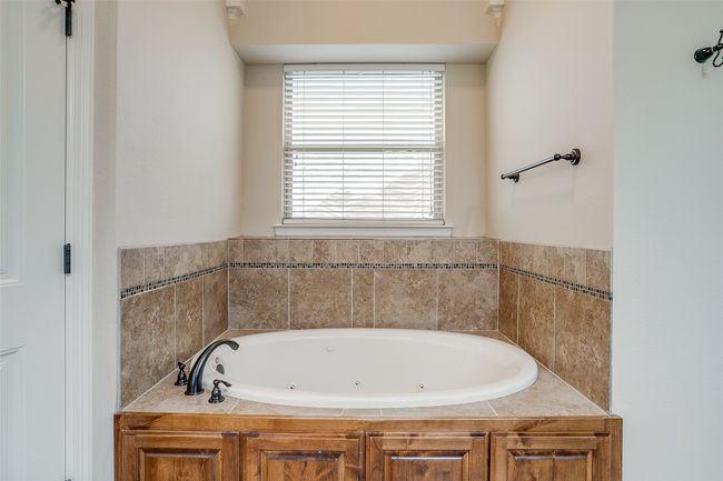 Bathroom featuring a whirlpool tub | Image 15