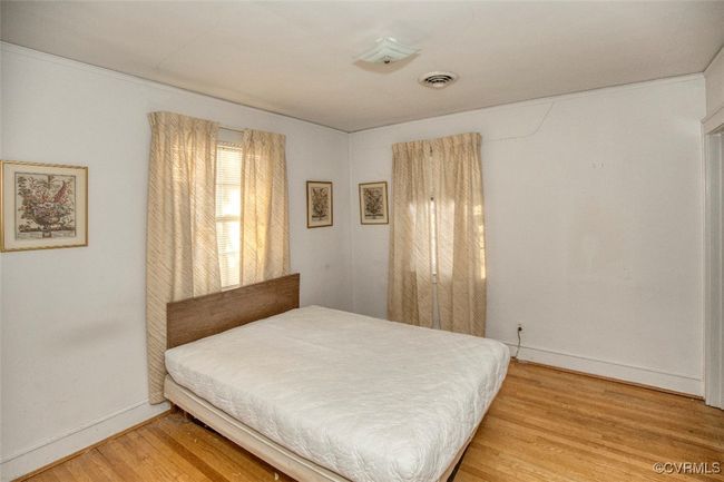 Bedroom with visible vents, baseboards, and light wood-type flooring | Image 19