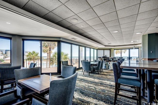 Dining space with a paneled ceiling and carpet | Image 31