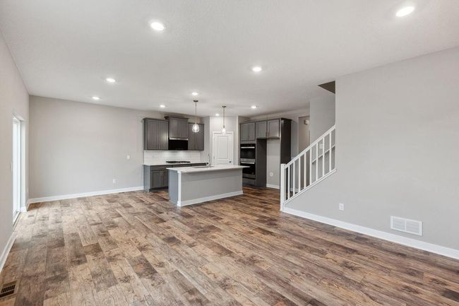 Another view of the kitchen, dinette and living room. Model photo. Options and colors will vary. | Image 10