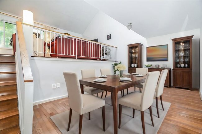 Dining room featuring high vaulted ceiling and wood-type flooring | Image 5