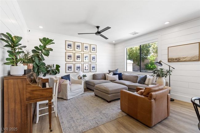 Living area with wood walls, visible vents, light wood-style floors, and ceiling​​‌​​​​‌​​‌‌​‌‌​​​‌‌​​‌‌​‌​​​​​‌ fan | Image 20