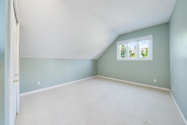 Bonus room featuring baseboards, lofted ceiling, and light colored carpet | Image 25