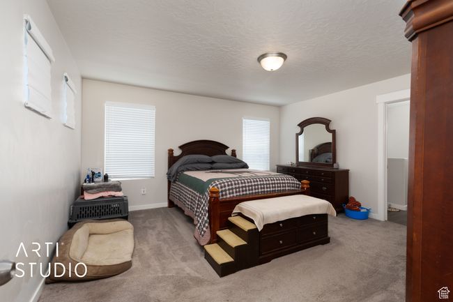 Carpeted bedroom featuring baseboards and a textured ceiling | Image 14