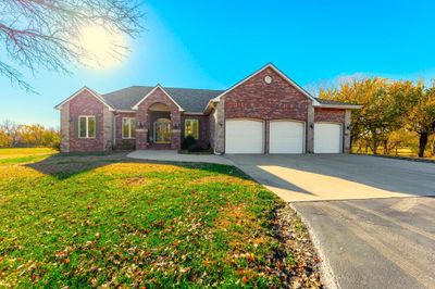 Ranch-style home featuring a garage and a front lawn | Image 1