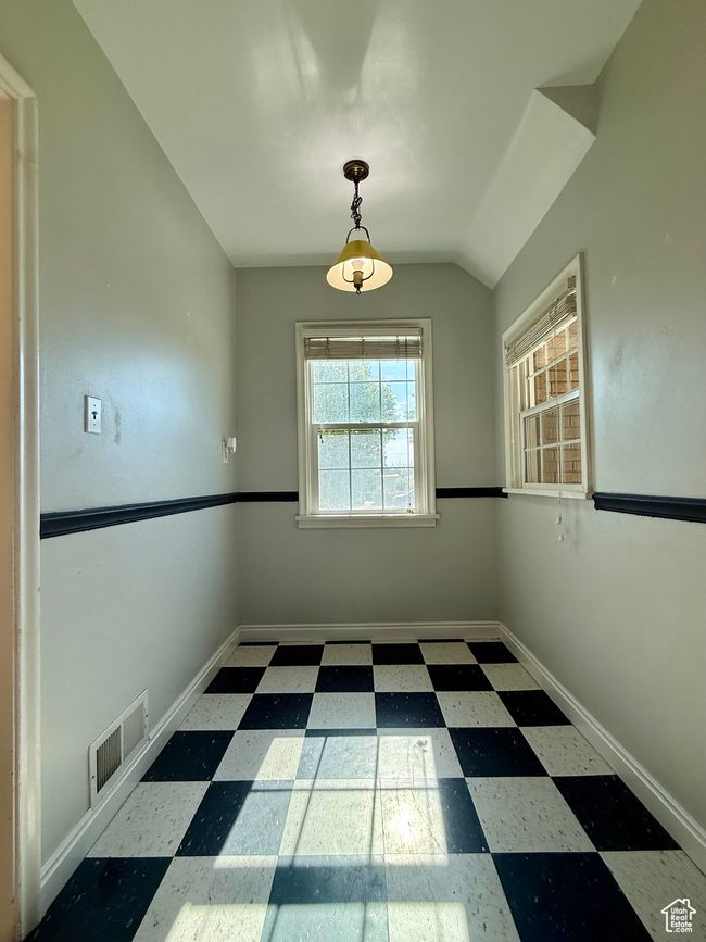 Unfurnished room featuring tile patterned floors, baseboards, and vaulted ceiling | Image 16