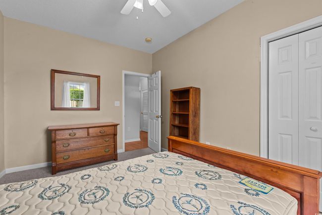 Bedroom featuring a closet, baseboards, ceiling fan, and carpet | Image 7